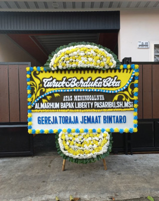 Papan Bunga Duka di Tiom